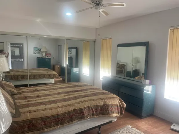 a bedroom with a large bed and a window