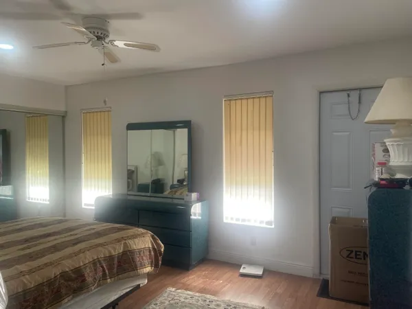 a bedroom with a bed and window with lamp