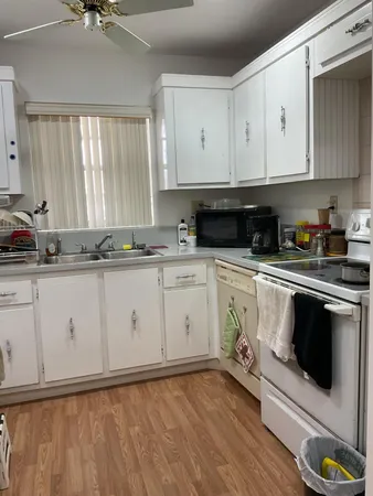 a kitchen with stainless steel appliances white cabinets and a sink