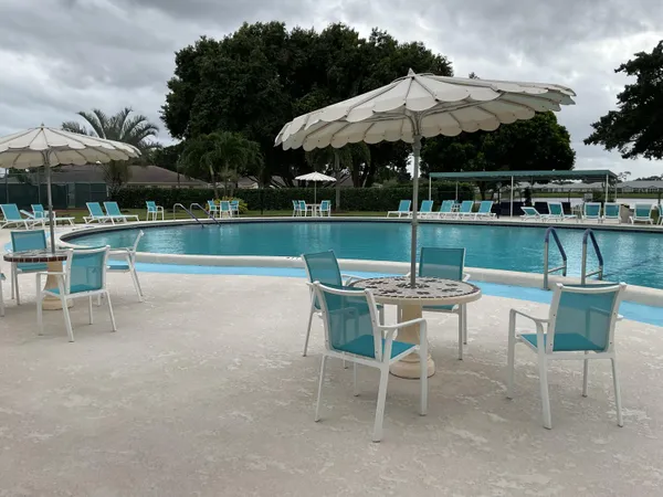 a view of a patio with a table chairs and a fire pit