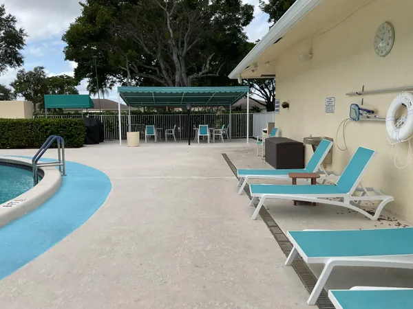 a view of a patio with a table and chairs