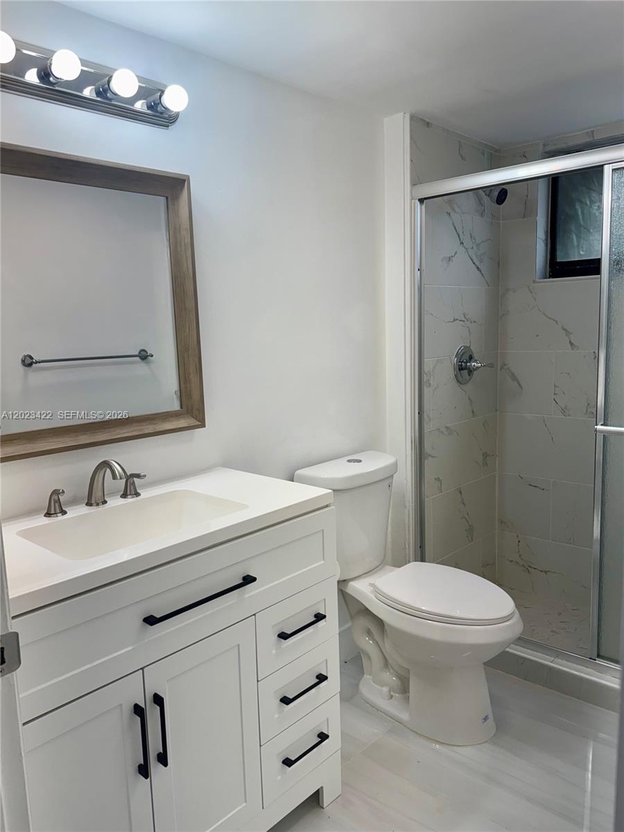 605 Ives Dairy Road, Unit 3067 Miami, FL 33179 - Photo 15 of 28 a bathroom with a sink toilet vanity and shower