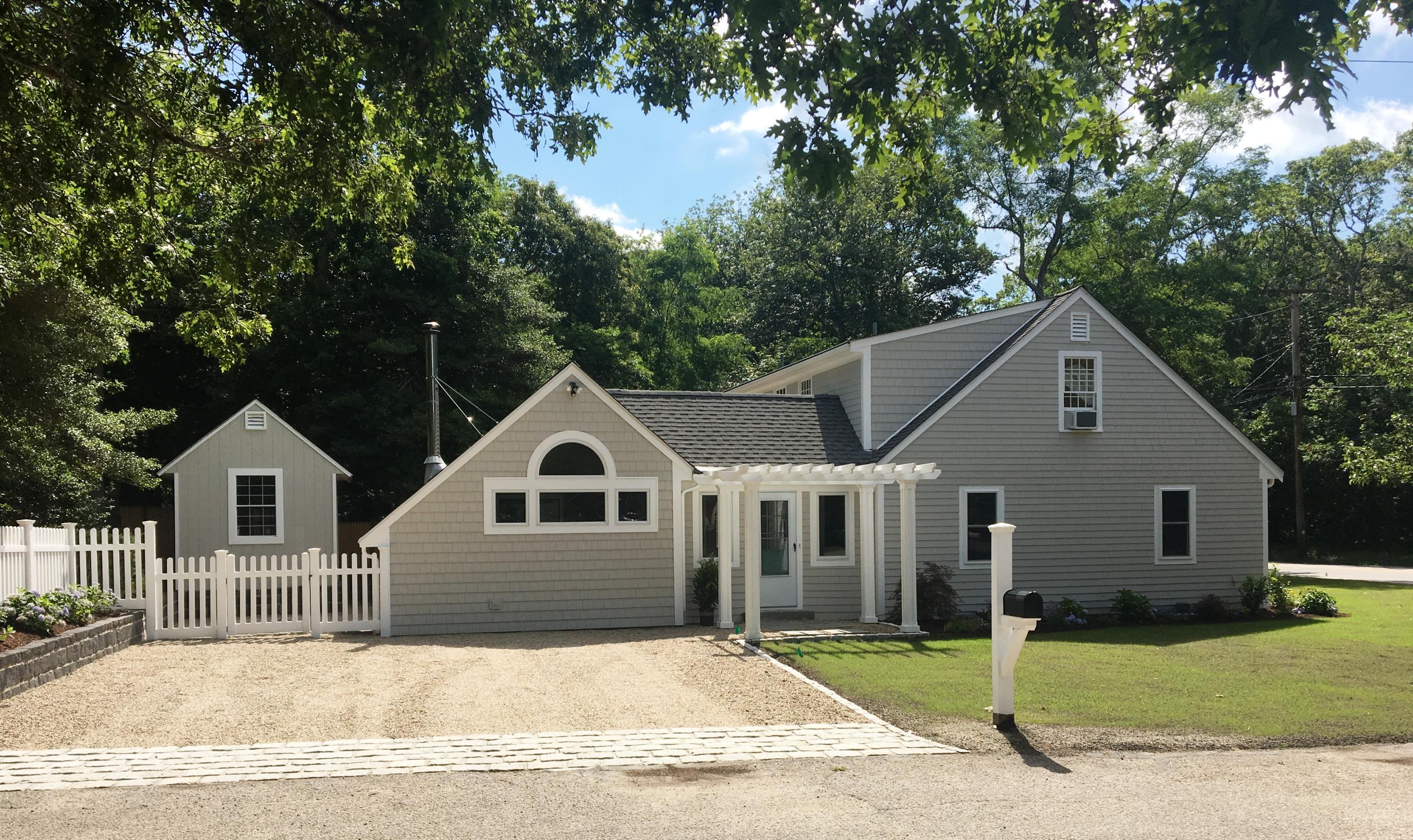 208 Great Marsh Road Centerville, MA 02632 - Photo 3 of 16 a view of a white house with a yard and large tree