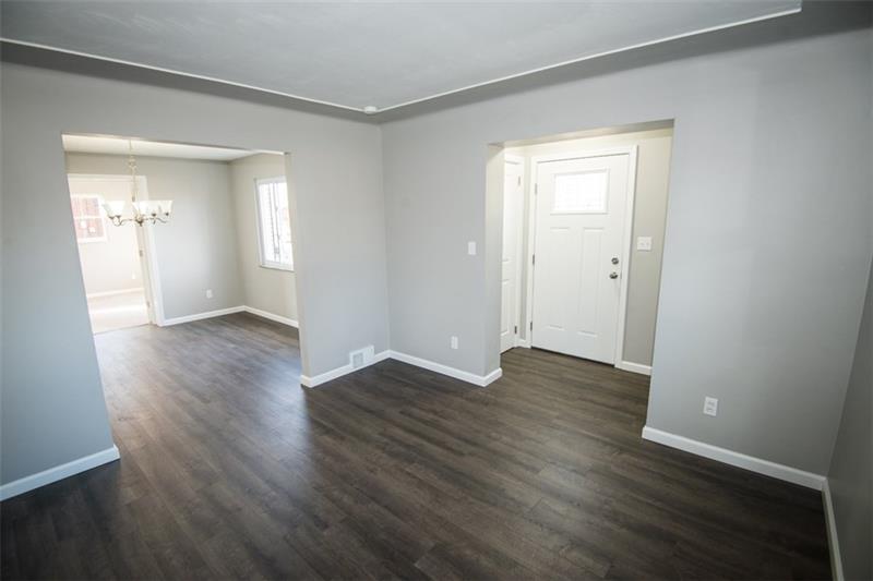 218 McClure Road Cheswick, PA 15024 - Photo 3 of 25 View of entryway with coat closet and living room opening to the dining room.