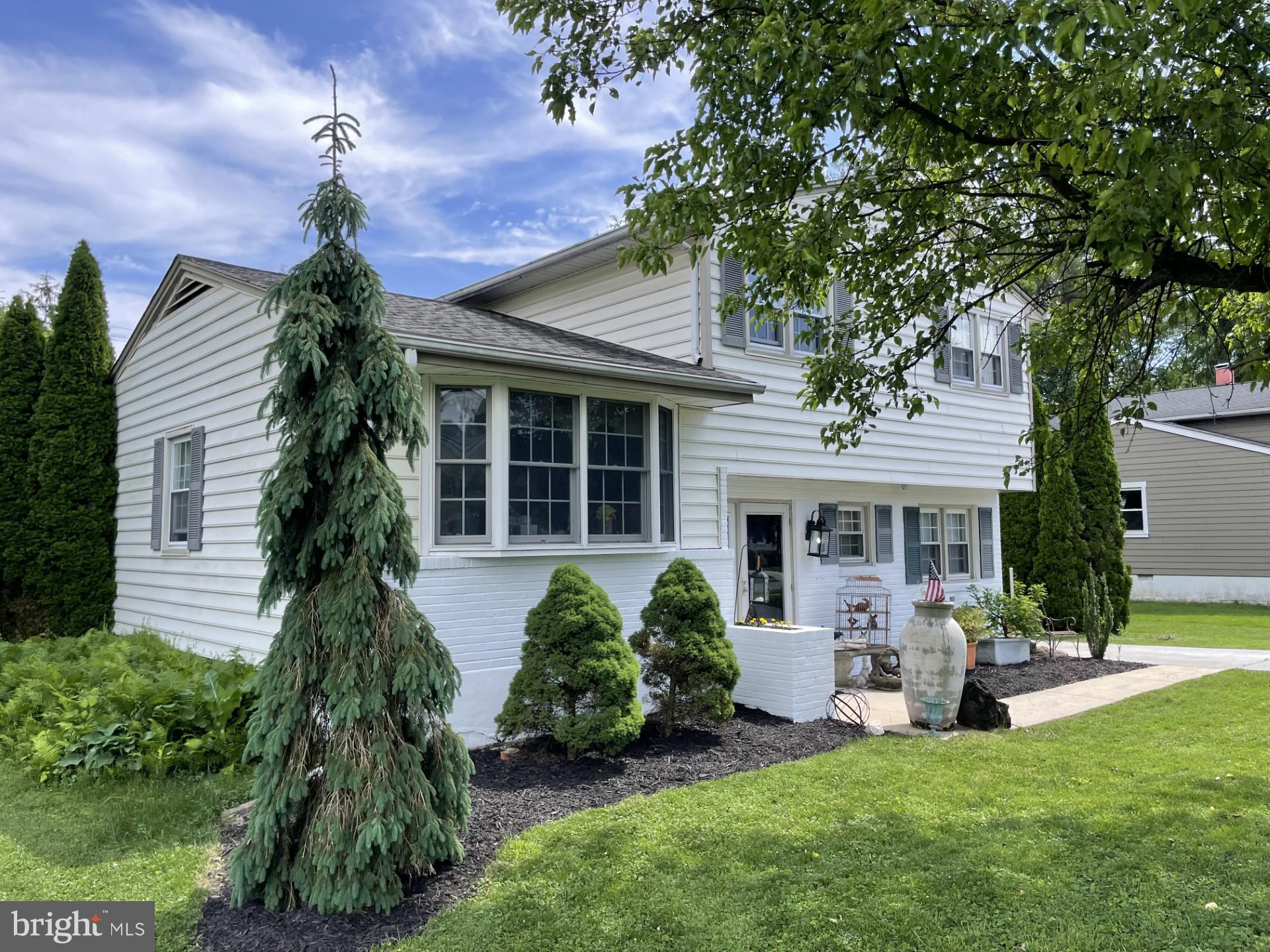 a front view of house with a garden