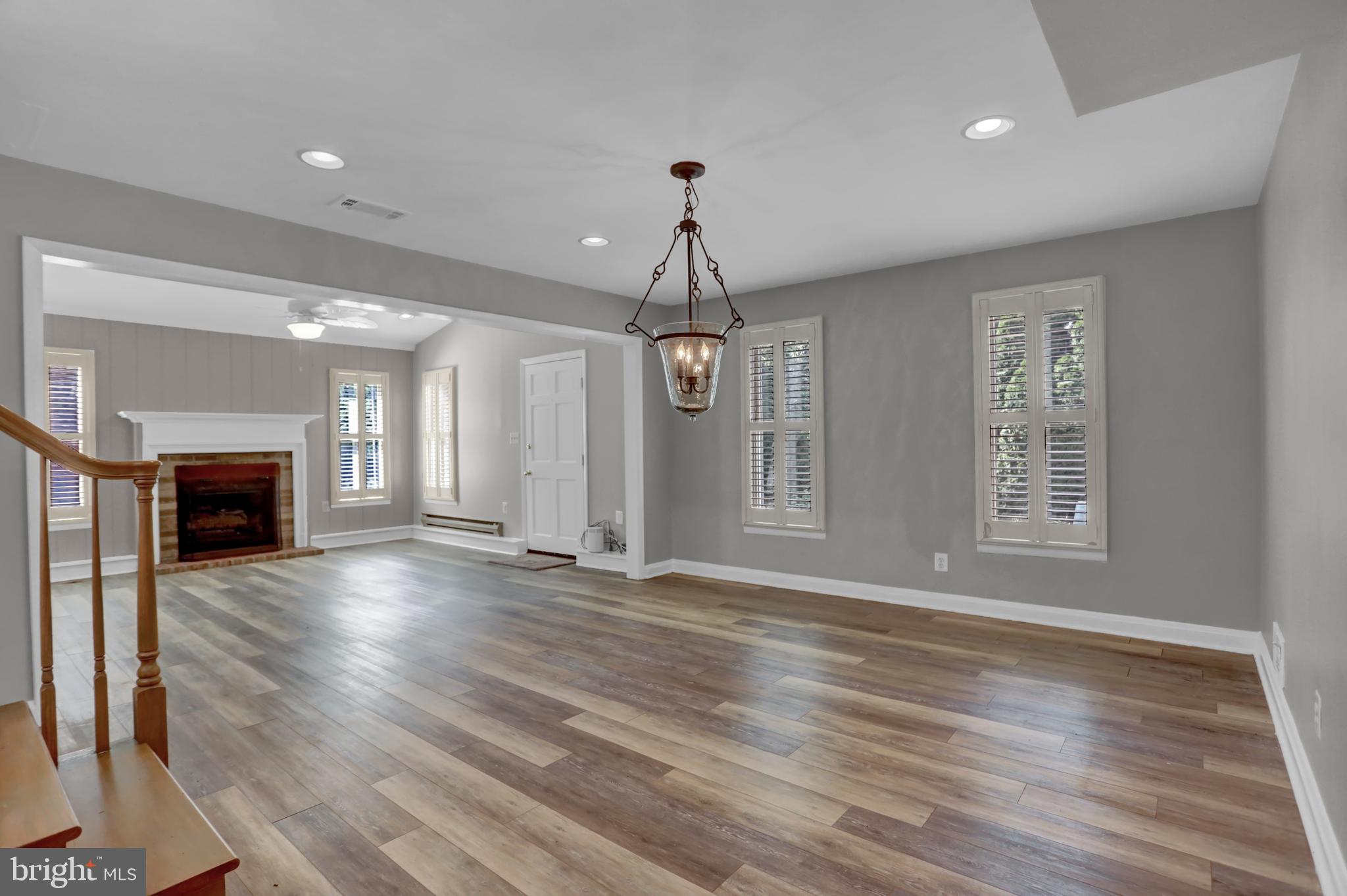829 Kellogg Road Lutherville-Timonium, MD 21093 - Photo 13 of 42 a view of an empty room with wooden floor fireplace and a window