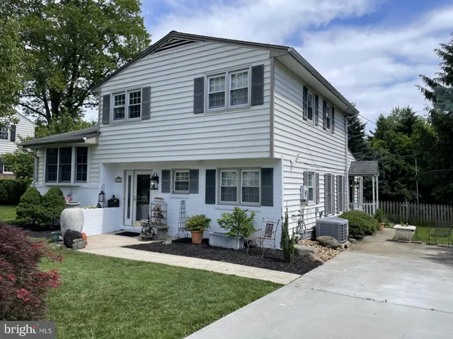 a front view of house with a garden and patio