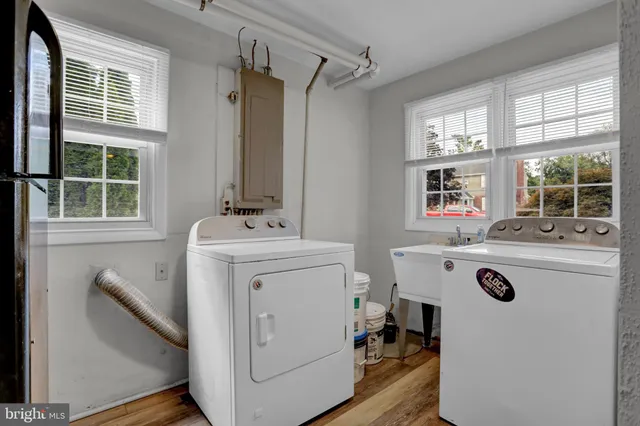 a view of washer and dryer with bathroom sink