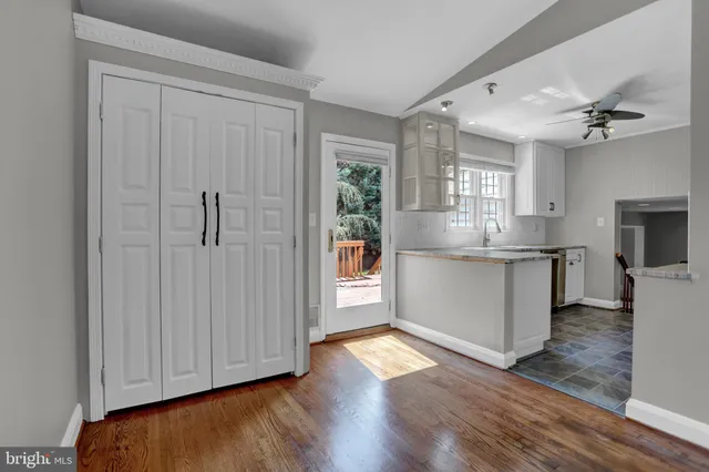 a view of kitchen with granite countertop cabinets stainless steel appliances and a window