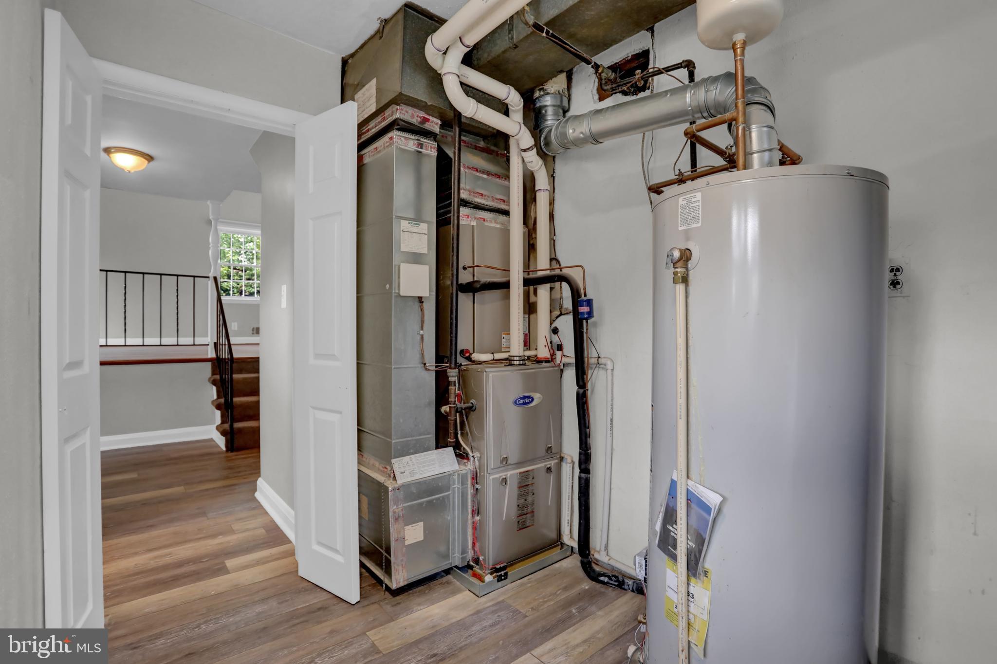829 Kellogg Road Lutherville-Timonium, MD 21093 - Photo 31 of 42 a view of a hallway with wooden floor and staircase