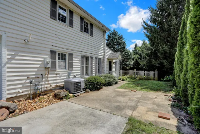a view of a patio with chair and tables back yard of the house