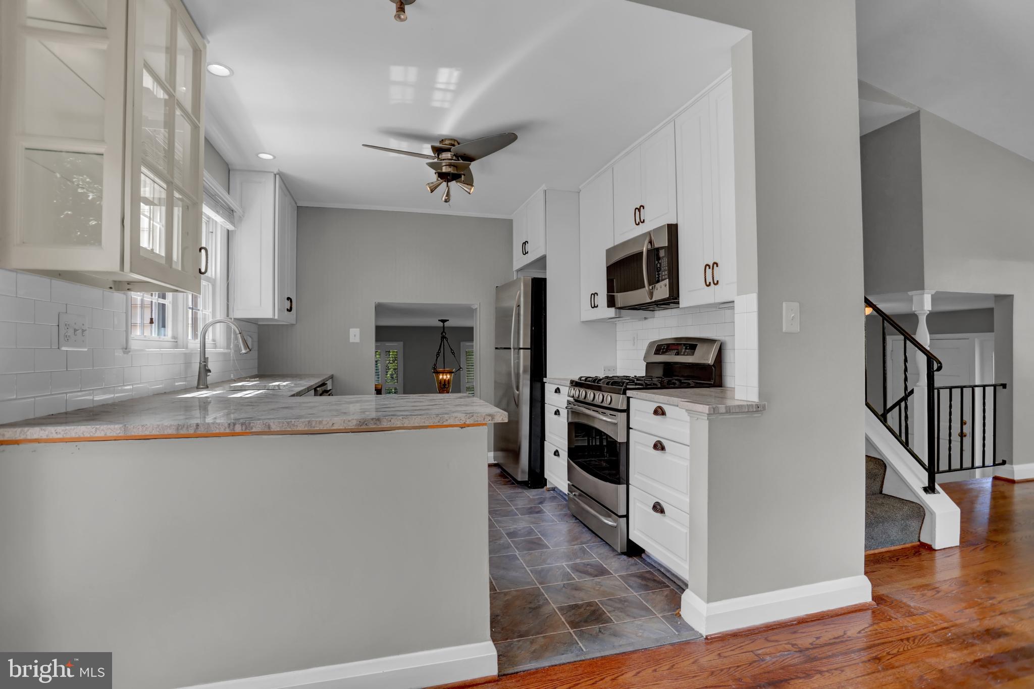 829 Kellogg Road Lutherville-Timonium, MD 21093 - Photo 5 of 42 a kitchen with kitchen island a stove a sink and a refrigerator