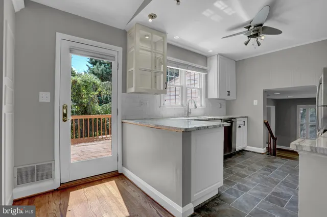 a kitchen with granite countertop a stove a sink and a refrigerator
