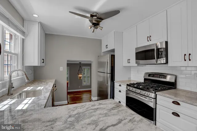 a kitchen with stainless steel appliances a stove a microwave and a refrigerator