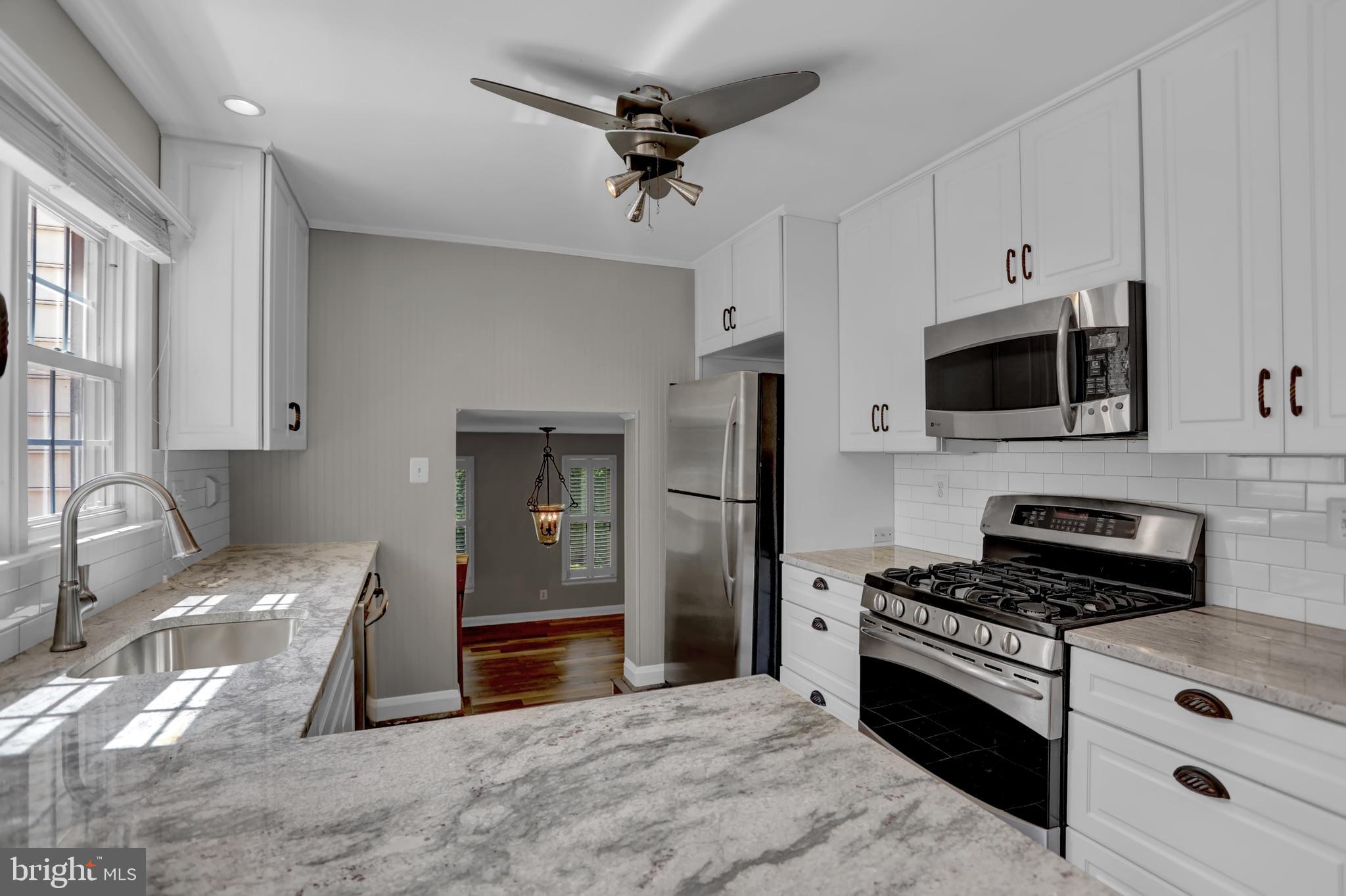 829 Kellogg Road Lutherville-Timonium, MD 21093 - Photo 7 of 42 a kitchen with stainless steel appliances a stove a microwave and a refrigerator