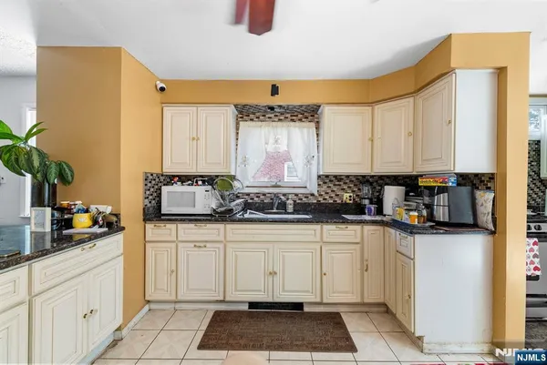 a kitchen with stainless steel appliances granite countertop a sink and cabinets
