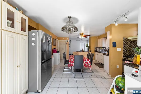a kitchen with stainless steel appliances granite countertop a refrigerator and a stove