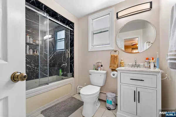 a bathroom with a toilet a sink and tub