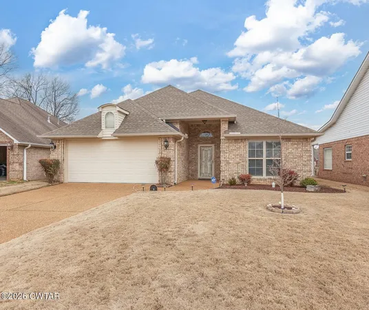 a backyard of a house with barbeque oven and outdoor seating