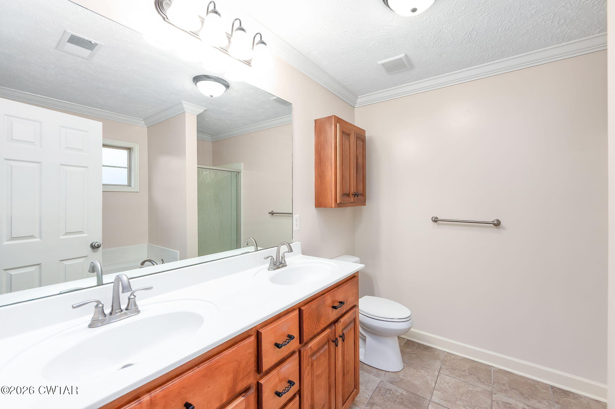 9 Sandbourne Cove Jackson, TN 38305 - Photo 10 of 22 a bathroom with a double vanity sink toilet and a mirror