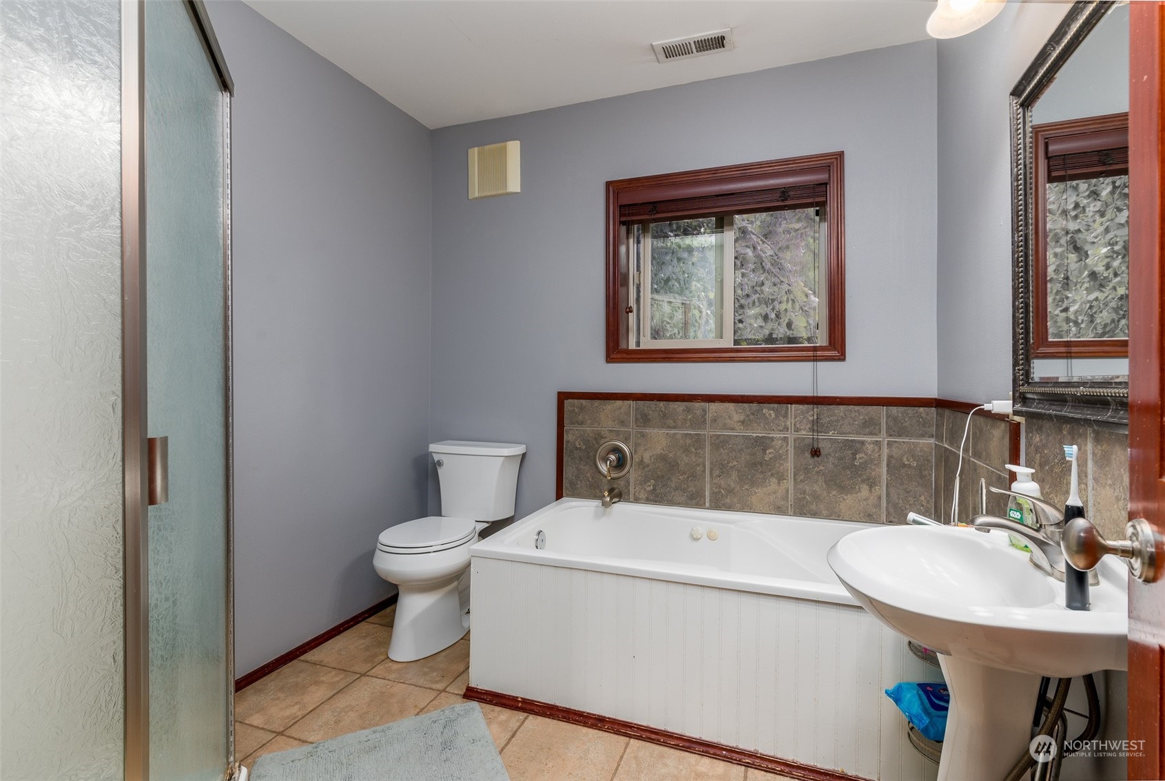 6283 Noon Road Everson, WA 98247 - Photo 23 of 40 a bathroom with a toilet a sink and a mirror