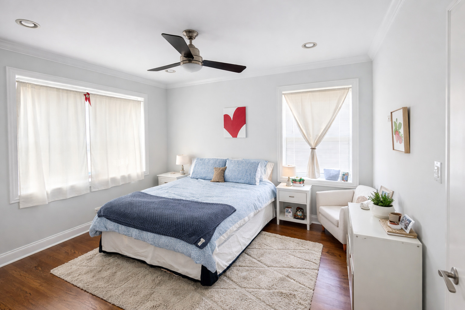 2467 North Clark Street, Unit 3 Chicago, IL 60614 - Photo 7 of 8 a spacious bedroom with a bed a chandelier and a window