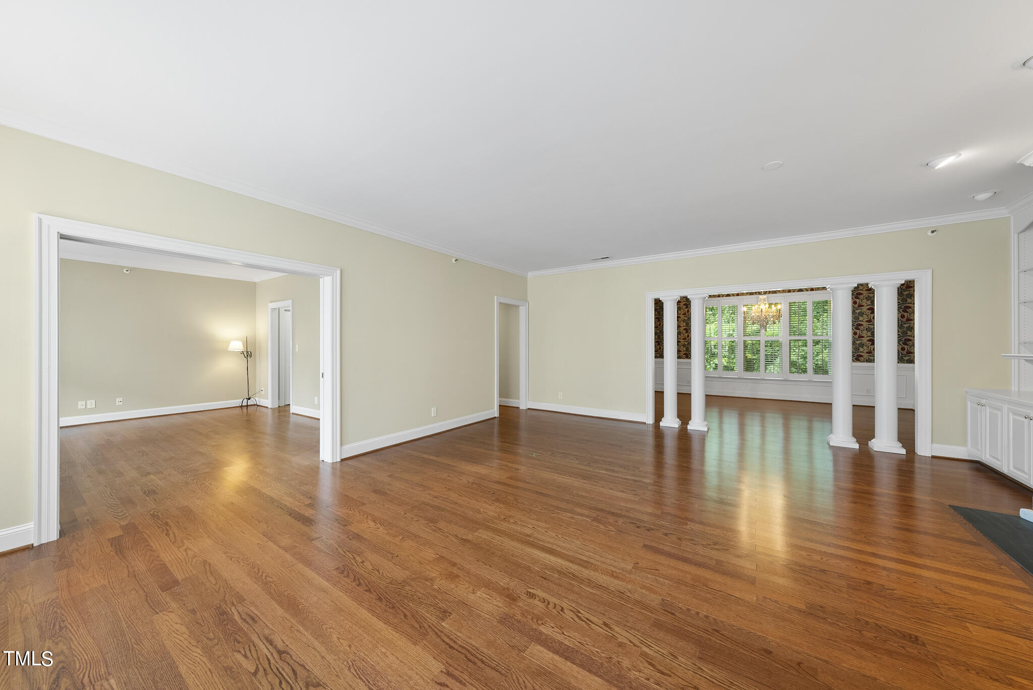 100 Edenburgh Road, Unit 304 Raleigh, NC 27608 - Photo 5 of 38 a view of empty room with wooden floor and floor to ceiling window