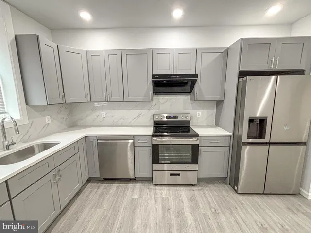 a kitchen with a refrigerator sink and microwave