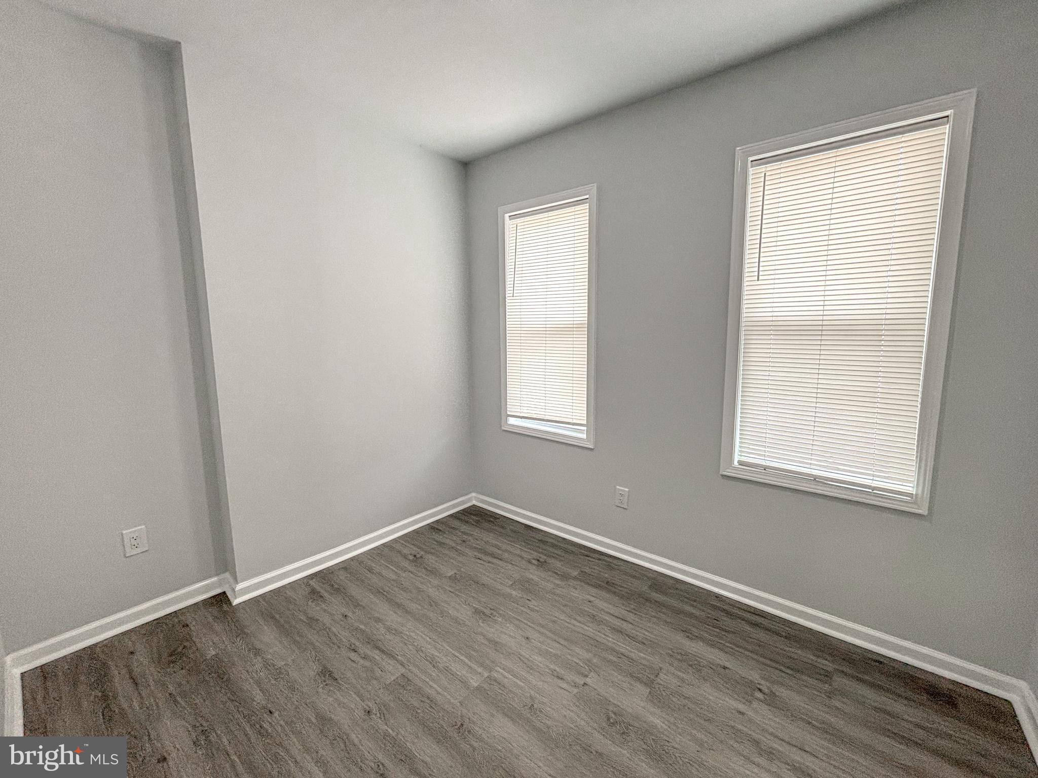 3631 Reed Street Philadelphia, PA 19146 - Photo 13 of 21 an empty room with wooden floor and windows