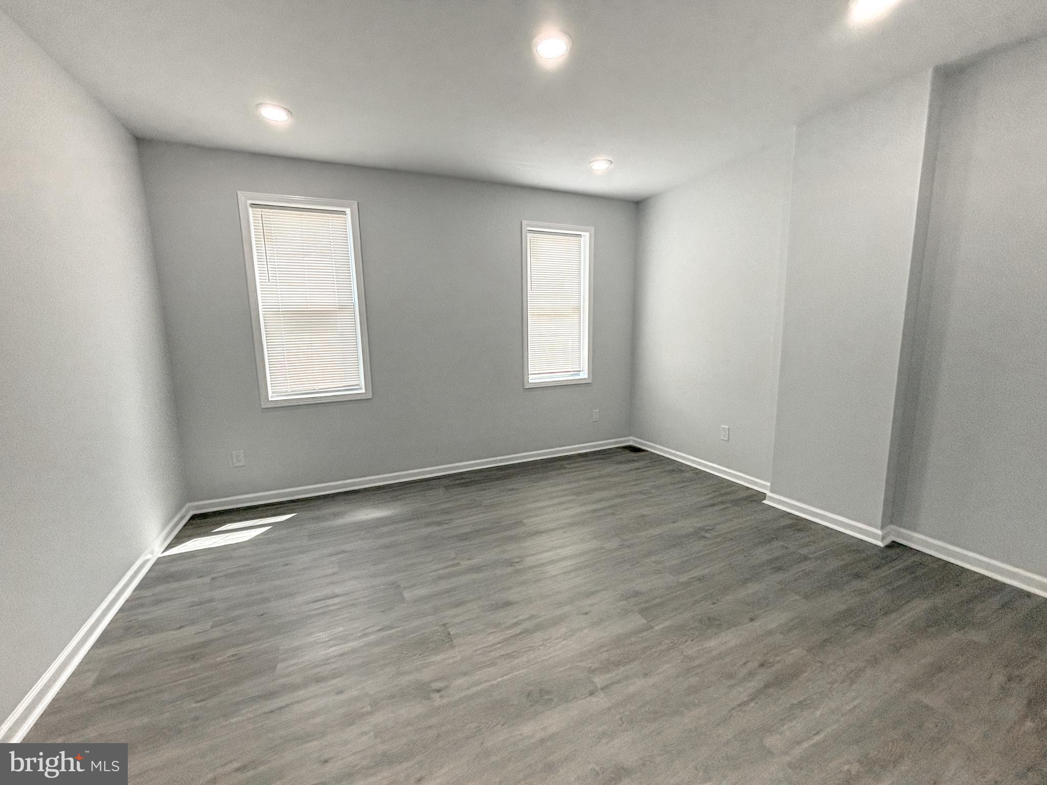3631 Reed Street Philadelphia, PA 19146 - Photo 17 of 21 an empty room with wooden floor and windows