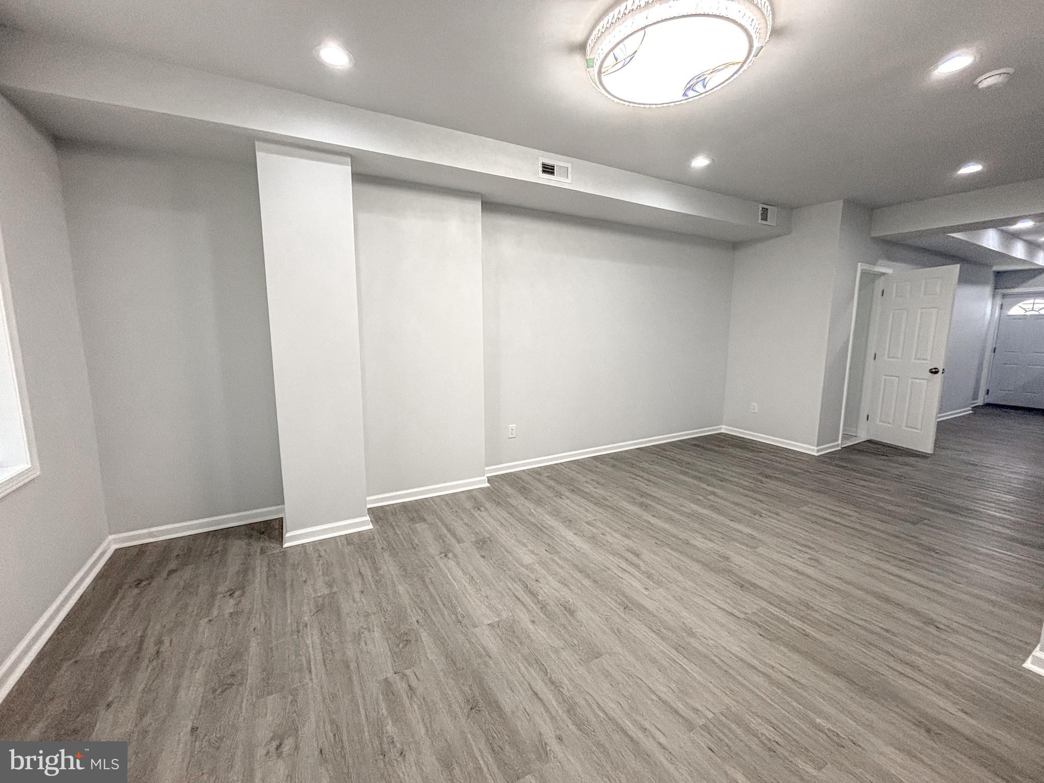 3631 Reed Street Philadelphia, PA 19146 - Photo 3 of 21 an empty room with wooden floor and windows