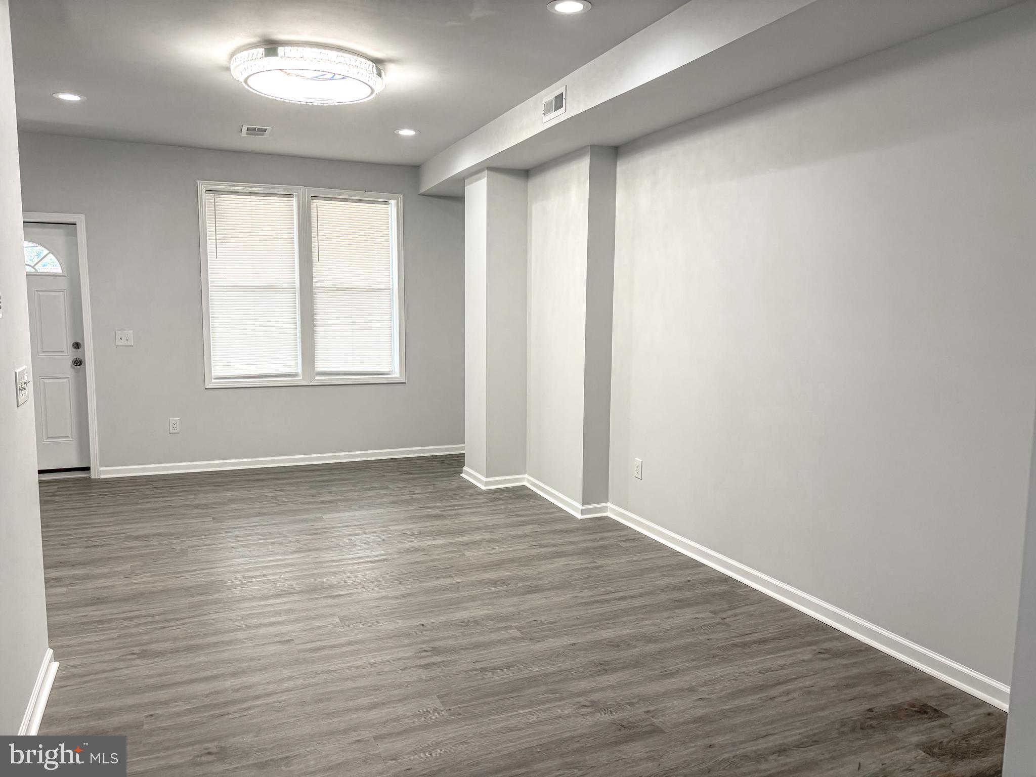 3631 Reed Street Philadelphia, PA 19146 - Photo 5 of 21 an empty room with wooden floor and windows