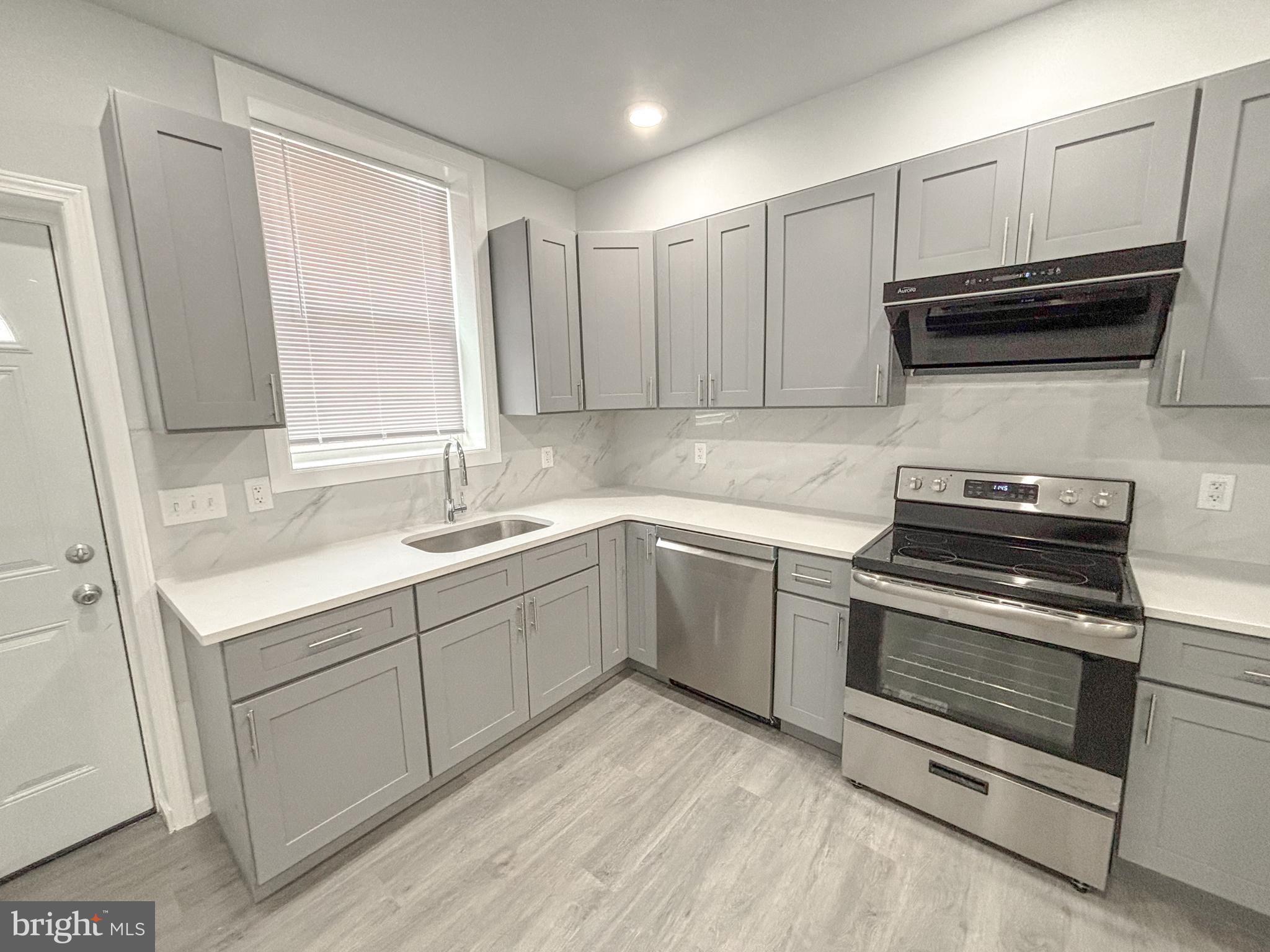 3631 Reed Street Philadelphia, PA 19146 - Photo 8 of 21 a kitchen with a sink stove and microwave