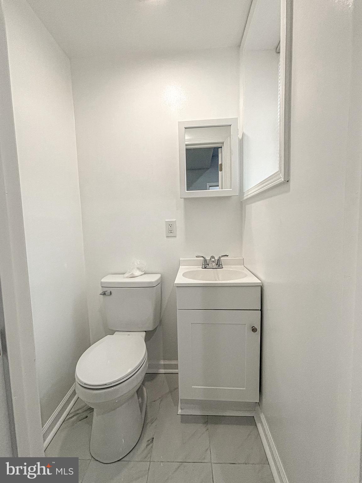 3631 Reed Street Philadelphia, PA 19146 - Photo 9 of 21 a bathroom with a toilet sink and mirror
