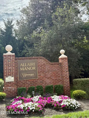 a sign that is in front of flowers