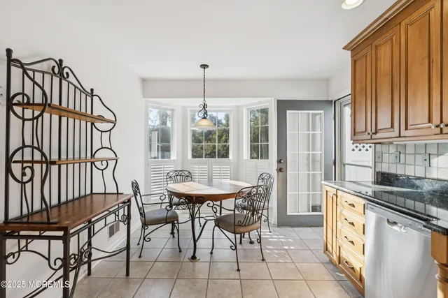 a kitchen with stainless steel appliances granite countertop a sink and a refrigerator