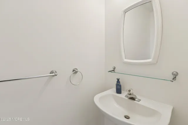 a bathroom with a sink and mirror