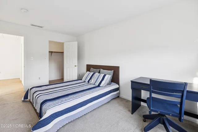 a bedroom with a bed and a desk