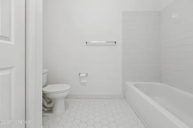 a bathroom with a toilet and a bathtub