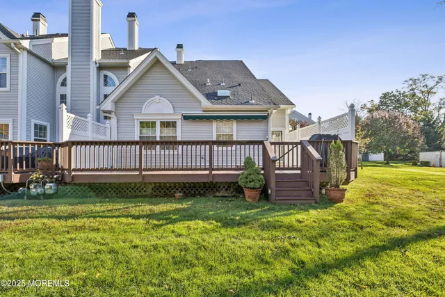 a view of a house with a yard and deck