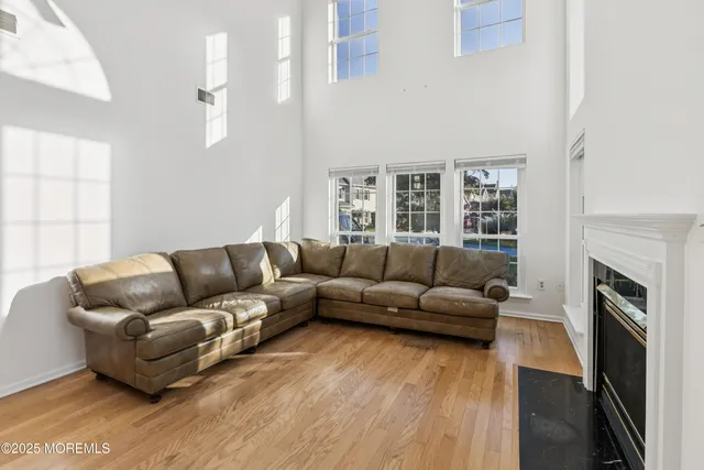 a living room with furniture a fireplace and a large window