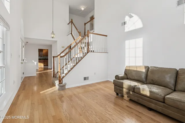 a living room with furniture and a hard wood floor