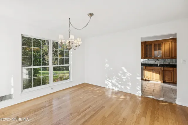 a view of a room with window and wooden floor