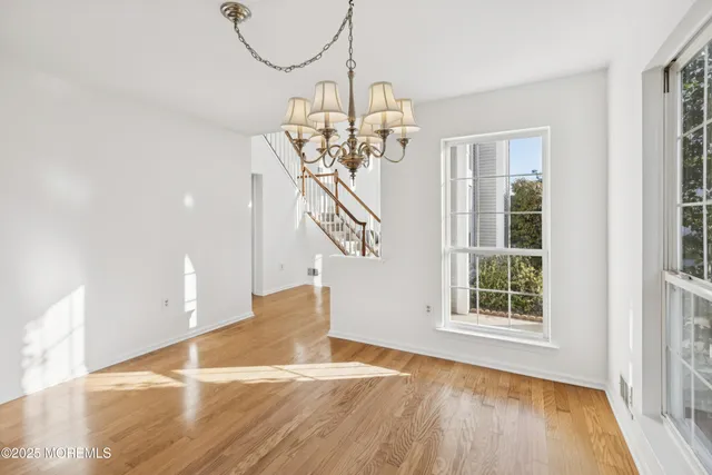 a view of a room with wooden floor and staircase