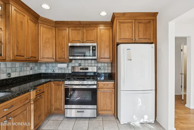 a kitchen with a refrigerator stove and microwave