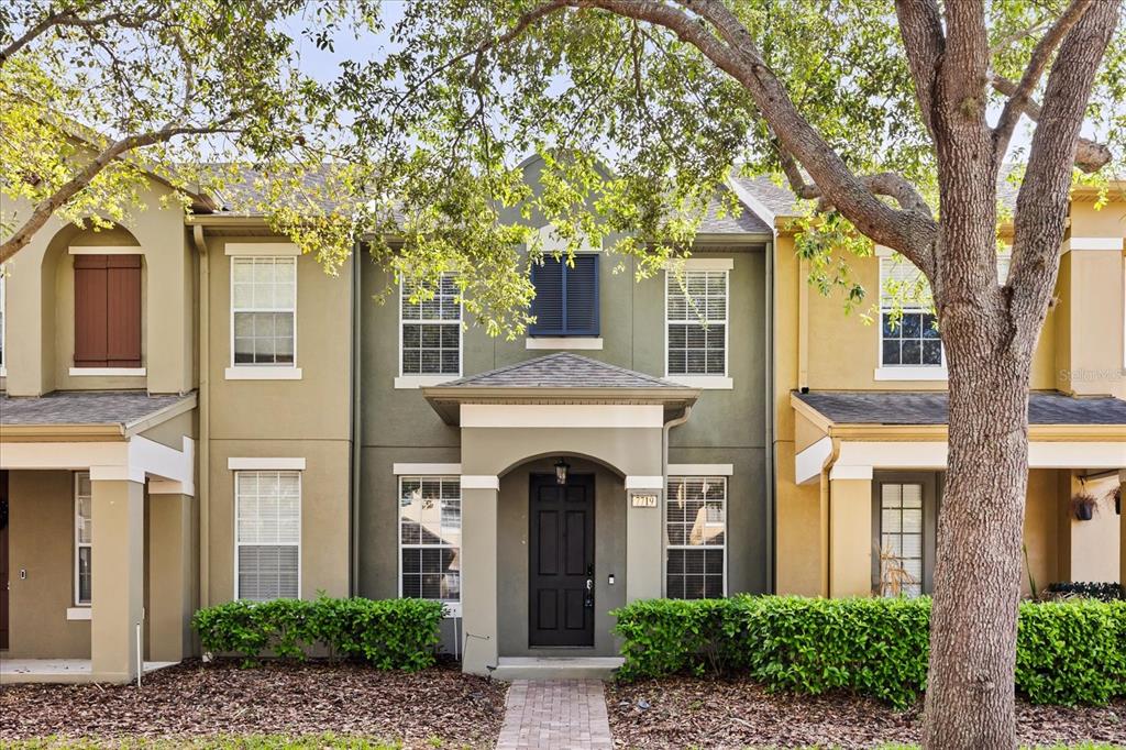 7719 Anselmo Lane Windermere, FL 34786 - Photo 1 of 31 a front view of a house with a garden