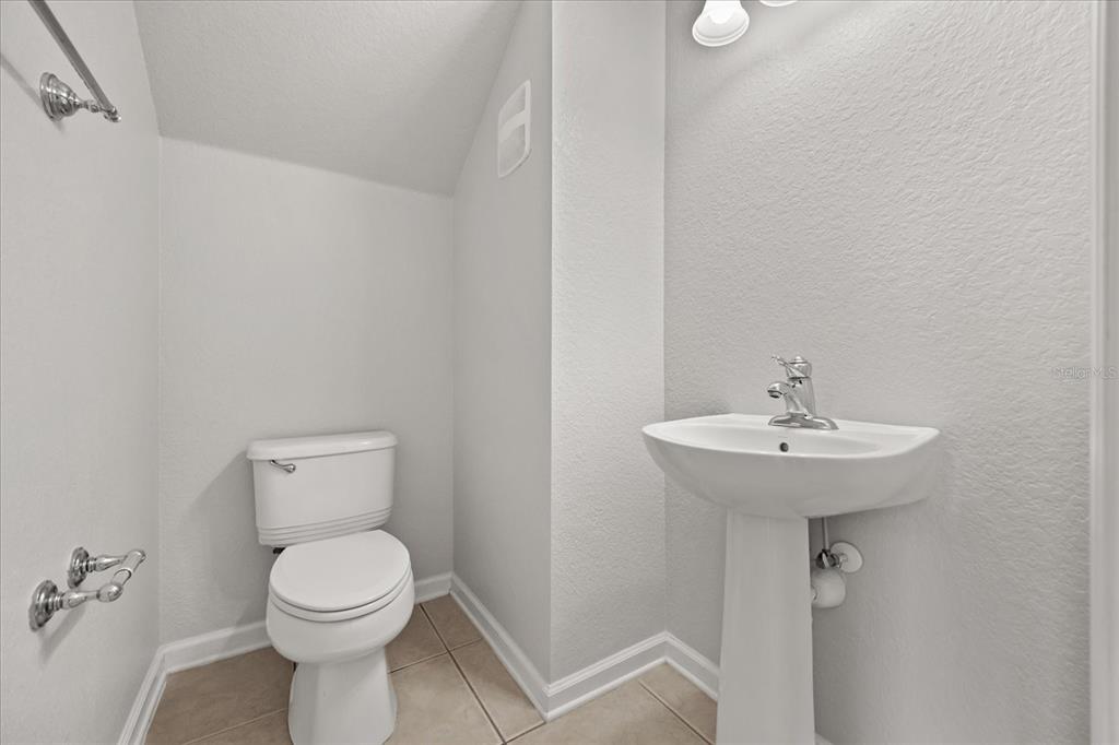 7719 Anselmo Lane Windermere, FL 34786 - Photo 13 of 31 a bathroom with a toilet sink and mirror
