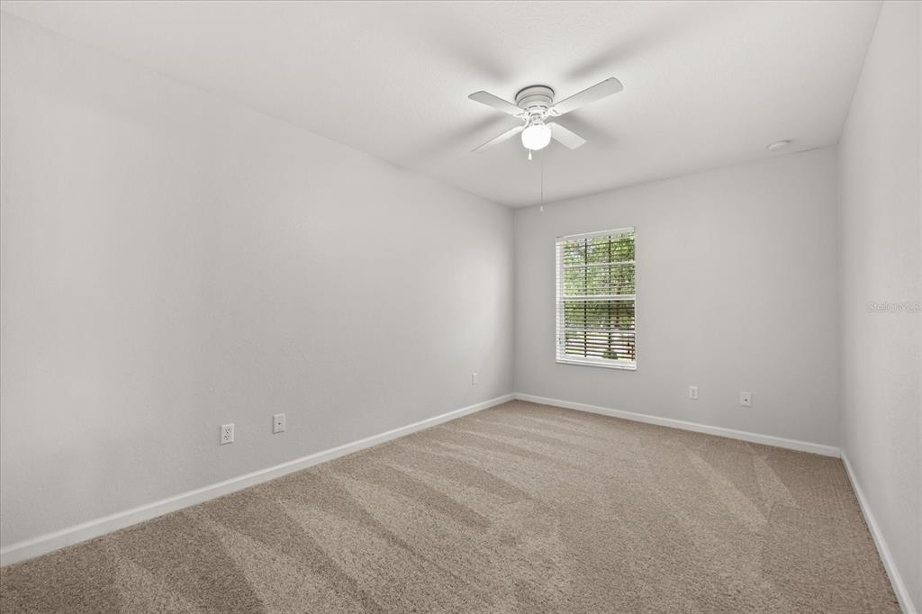 7719 Anselmo Lane Windermere, FL 34786 - Photo 24 of 31 an empty room with windows and fan