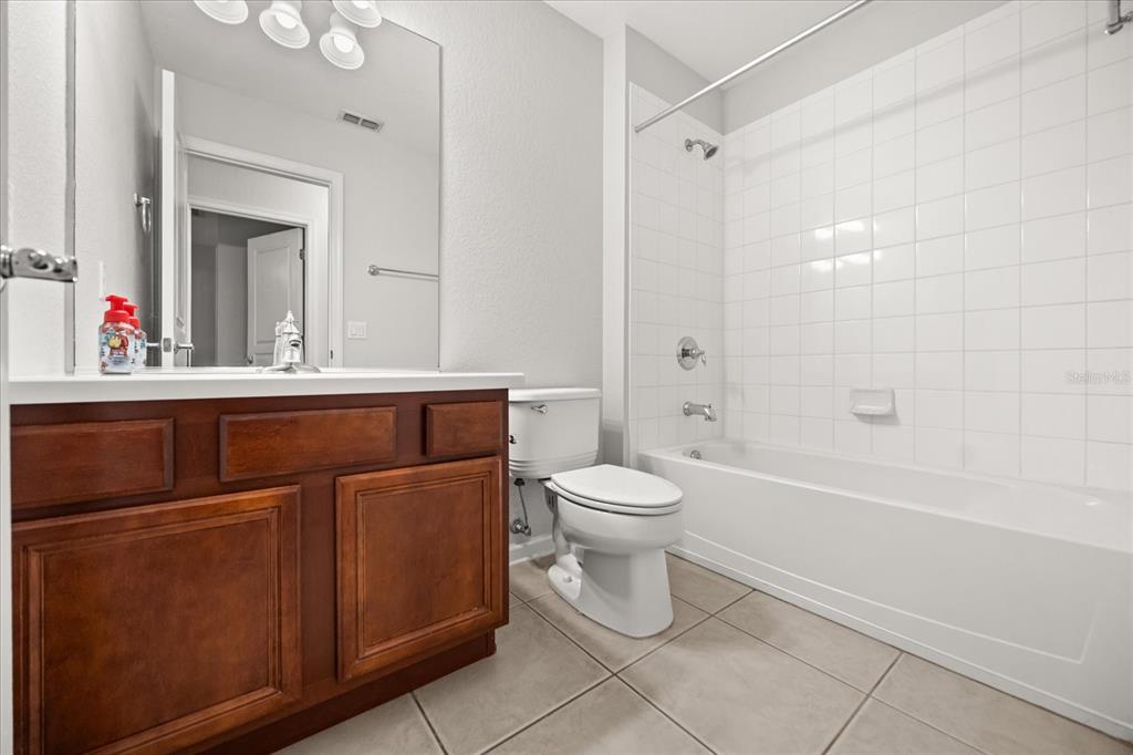 7719 Anselmo Lane Windermere, FL 34786 - Photo 26 of 31 a bathroom with a toilet sink and mirror