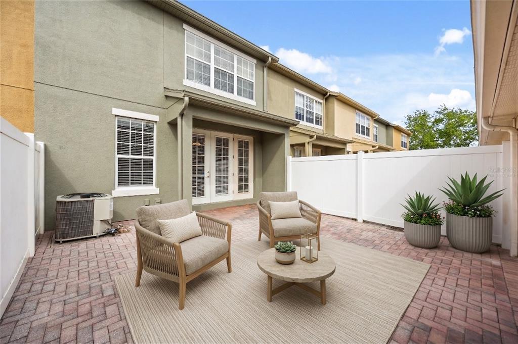 7719 Anselmo Lane Windermere, FL 34786 - Photo 28 of 31 a view of a patio with couches and potted plants